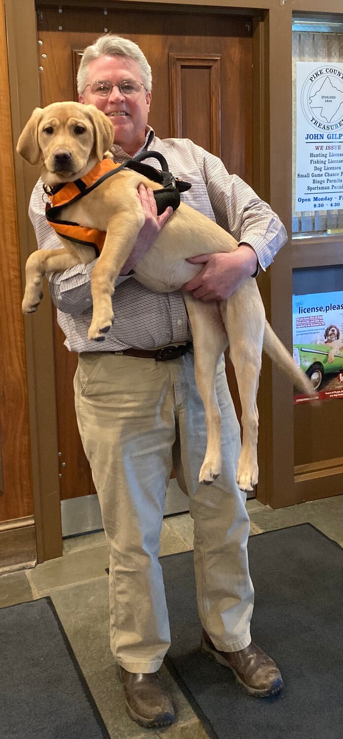 Pike County Treasurer John Gilpin and his puppy, Maine.